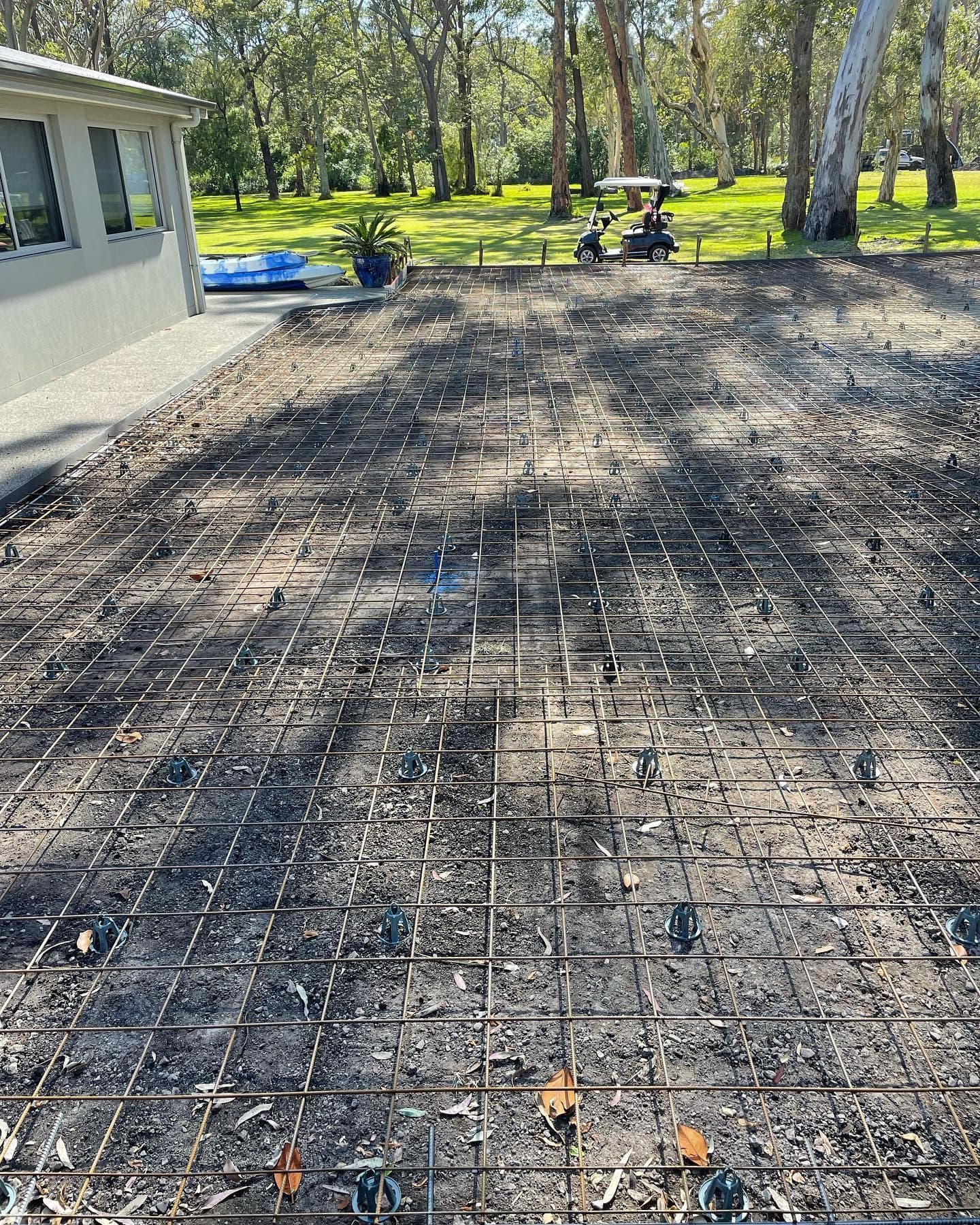 Reinforcing mesh set out before a driveway pour