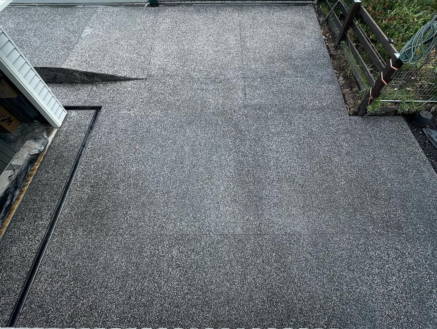 The basalt-mix driveway from the street