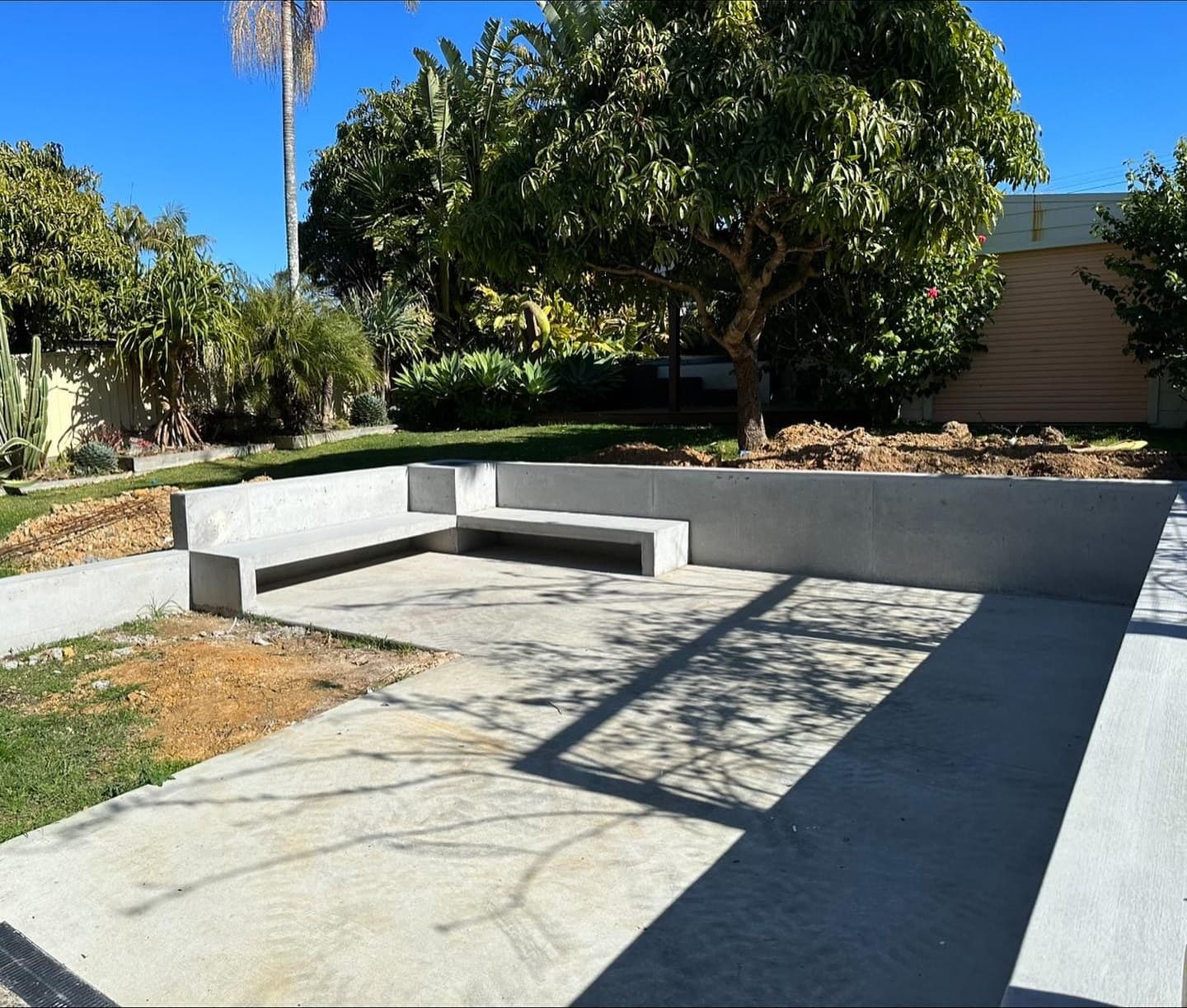 The finished fire-pit area with concrete seating