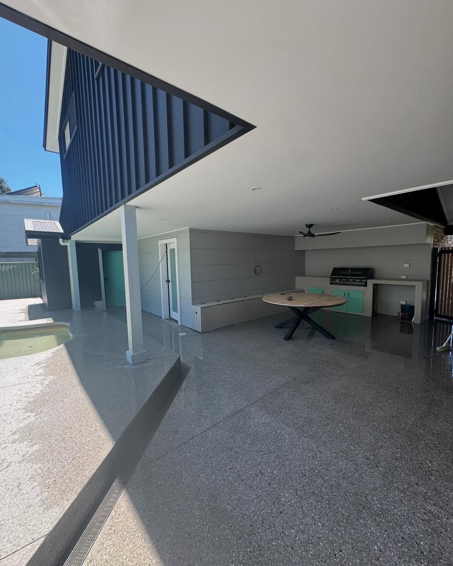Exposed driveway meeting the timber garage door, Norah Head