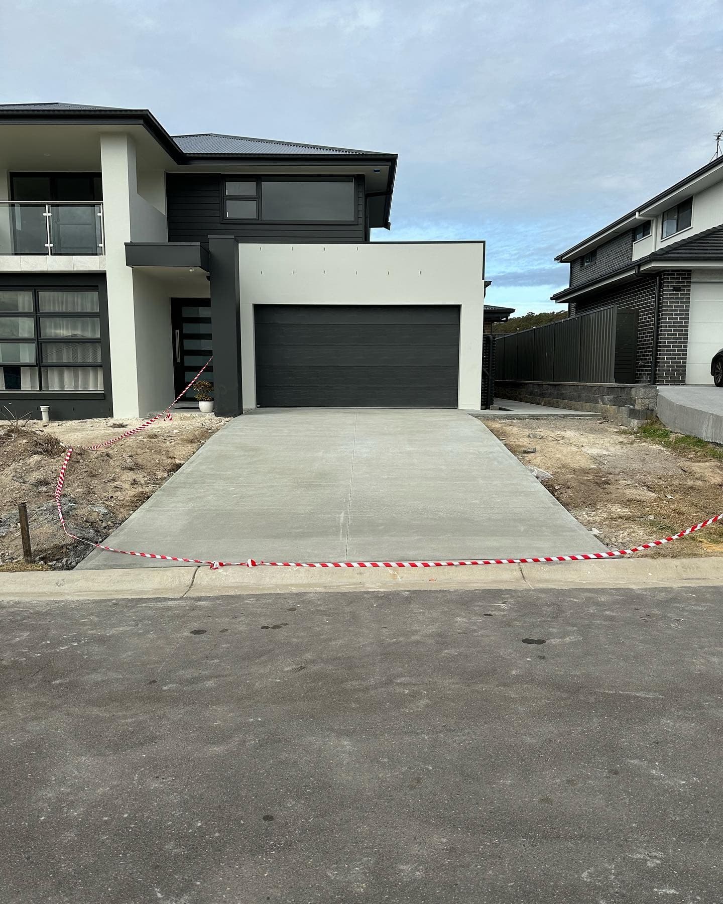 Plain grey broomed driveway at Wyee